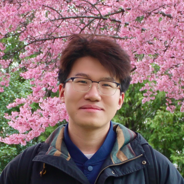 Portrait of Dongyu Gong in front of a blossoming cherry tree
